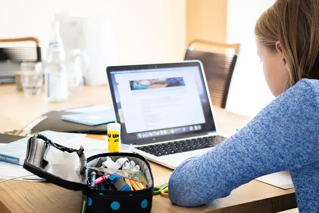 Girl learn Korean online on her laptop from the comfort of her home