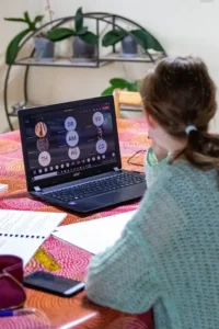 Asian girl learn Chinese online on her laptop in the sitting-room