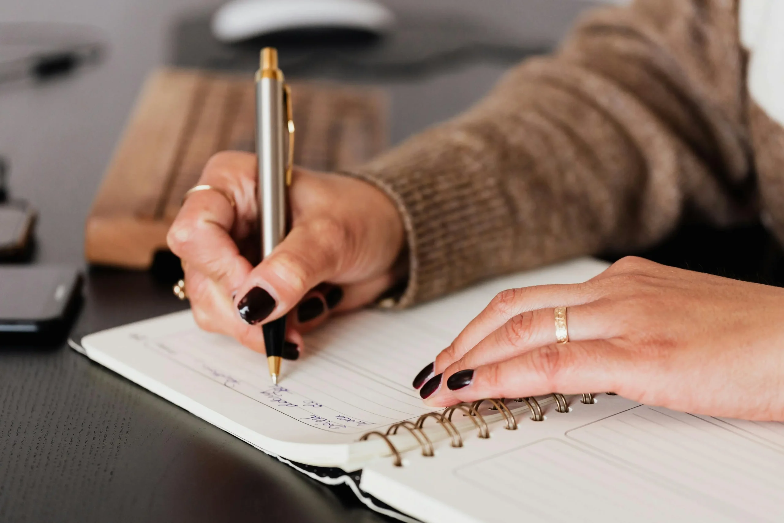 A girl taking note with her book and pen using the Cornell effective note taking methods